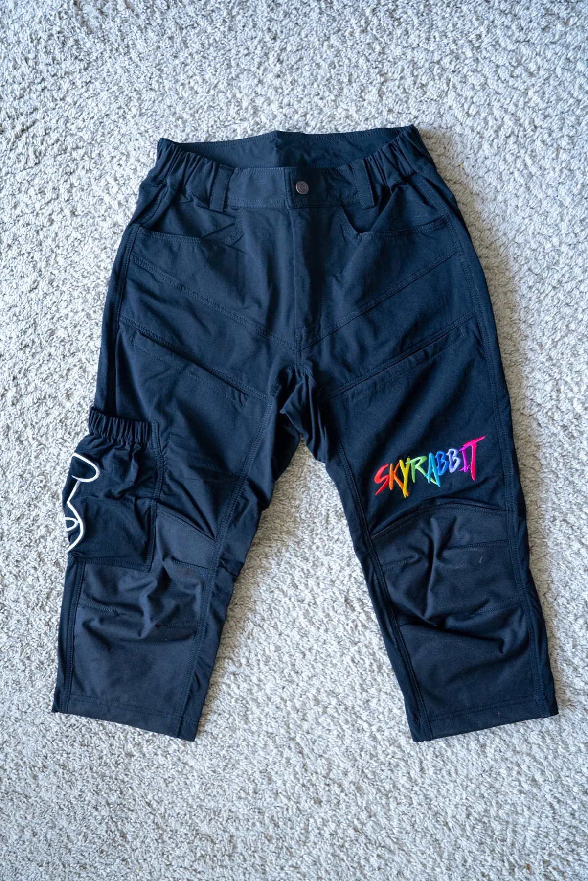 Skyrabbit Swooper shorts flat lay with embroidered wordmark